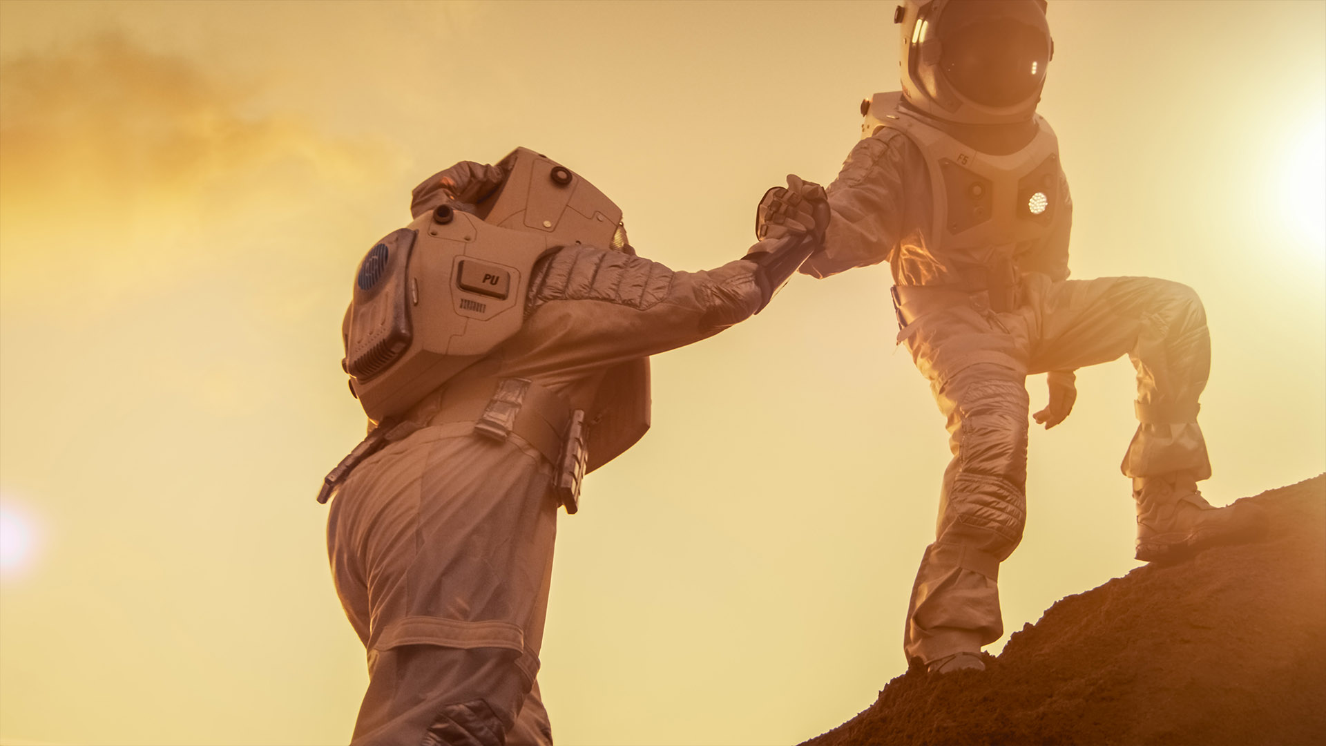 Dua astronot mendaki gunung saling membantu.